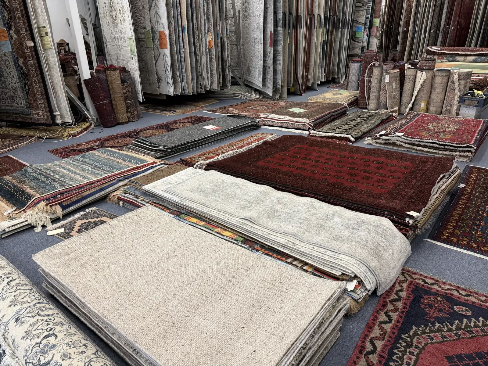 Handmade wool rugs and runners arranged in the showroom
