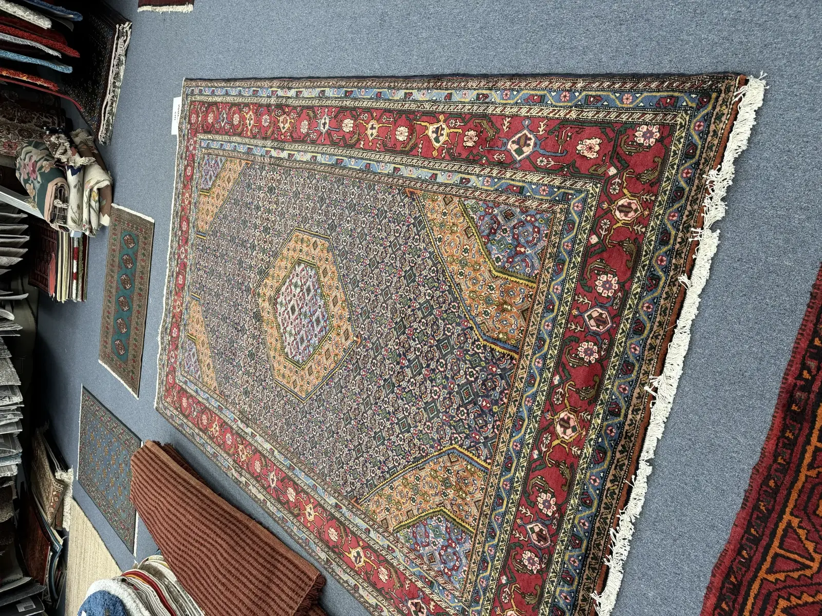 Detailed Persian rug displayed at the Royal Persian Carpets showroom