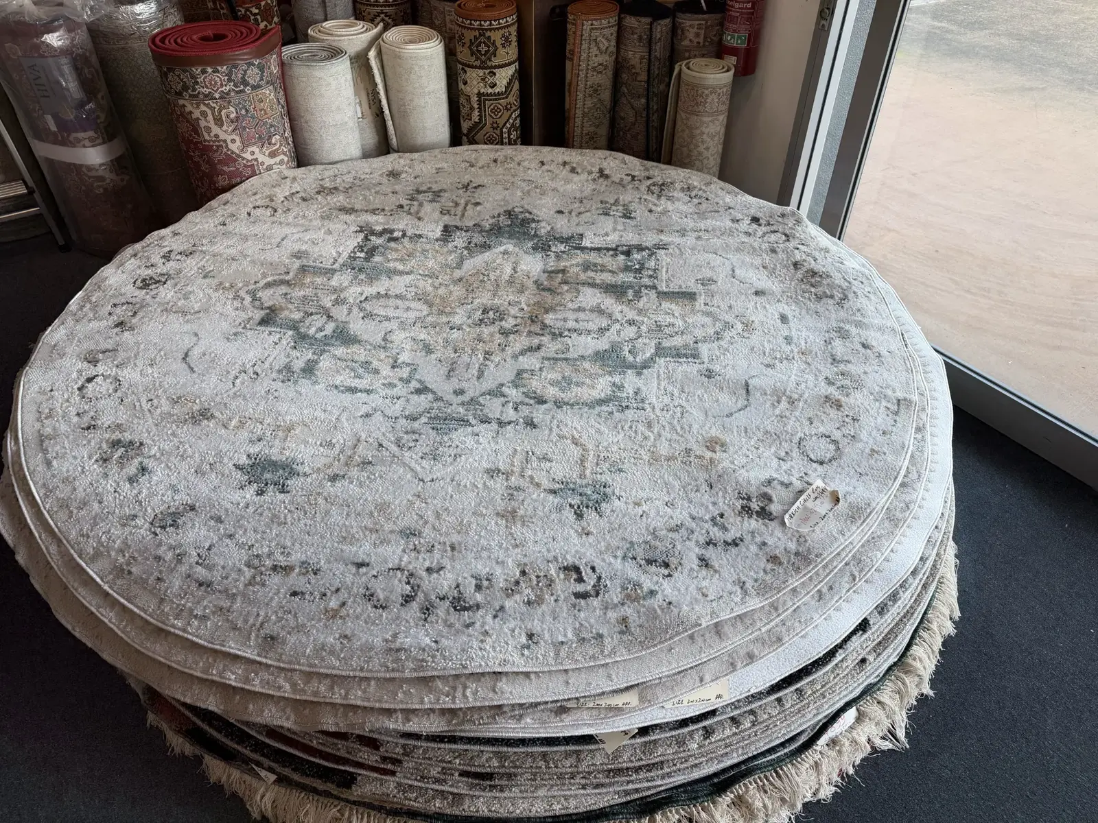 Stack of round rugs available at Royal Persian Carpets